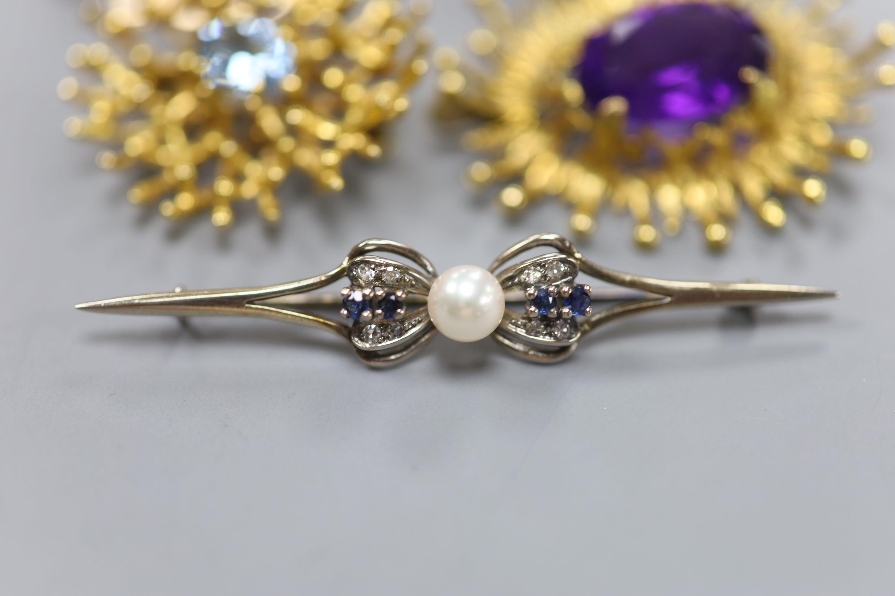 A modern 9ct white metal, sapphire, diamond and cultured pearl set bar brooch, 61mm and four other modern 9ct gold and gem set brooches, including amethyst and smoky quartz